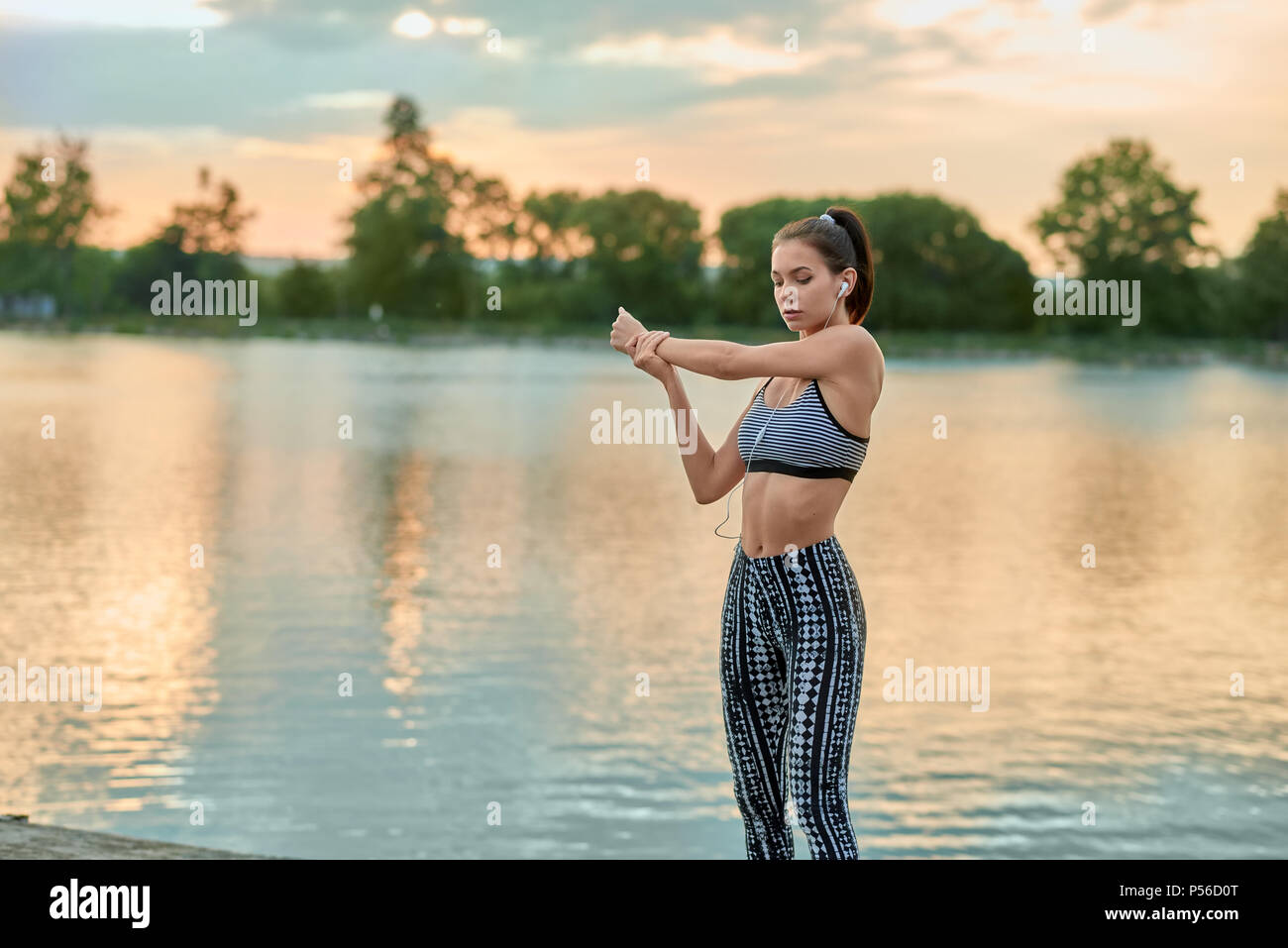 Sportliche Aktivitaten In Der Nahe Der Abendlichen See Madchen Mit Stilvollen Modernen Sportbekleidung Modell Suchen Schlank Fit Gesunde Lebensweise In Hubschen Gesicht Schones Bild Warmes Sommerwetter Suche Auf Der Seite Stockfotografie
