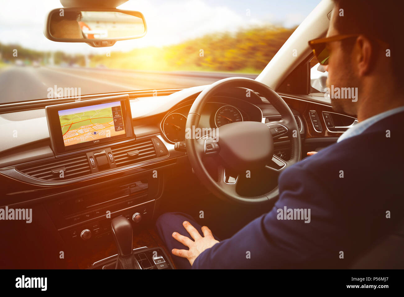 Der Mensch hinter dem Lenkrad Sonnenbrille tragen Stockfoto