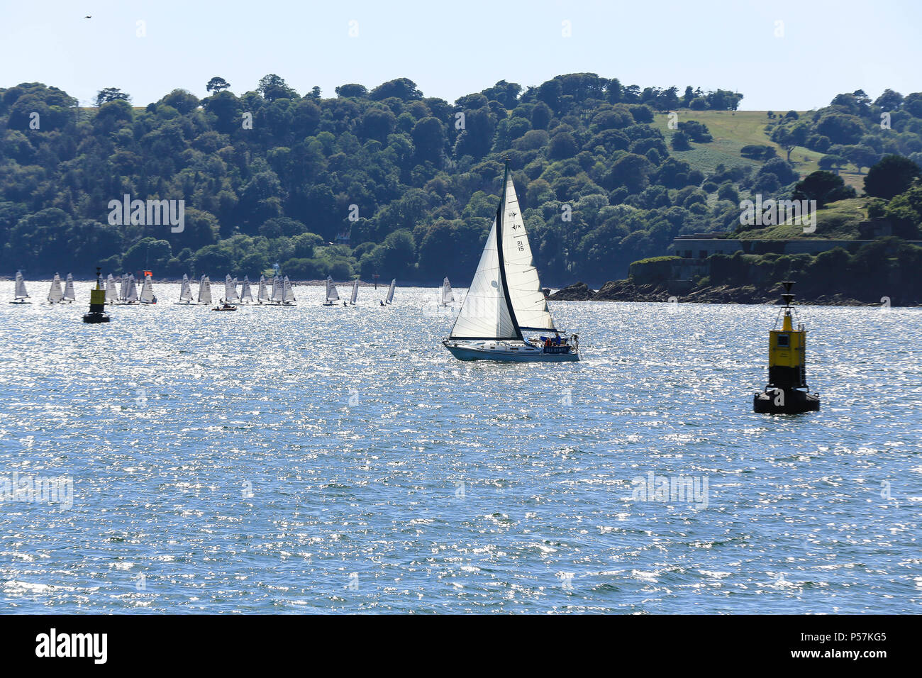 Yacht segeln vorbei an einigen racing Jollen Stockfoto