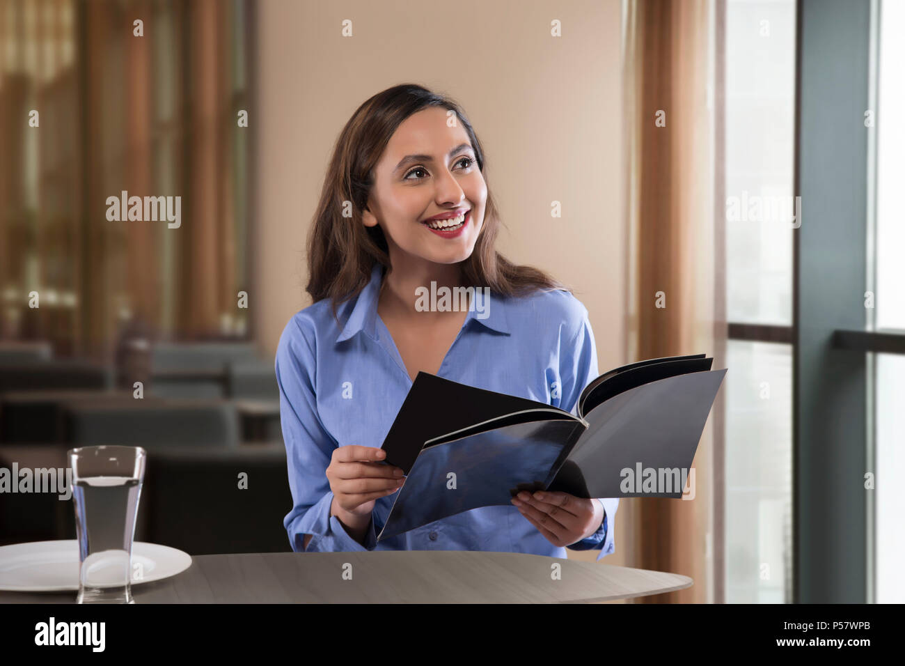 Geschäftsfrau lesen Magazin auf Tisch Stockfoto