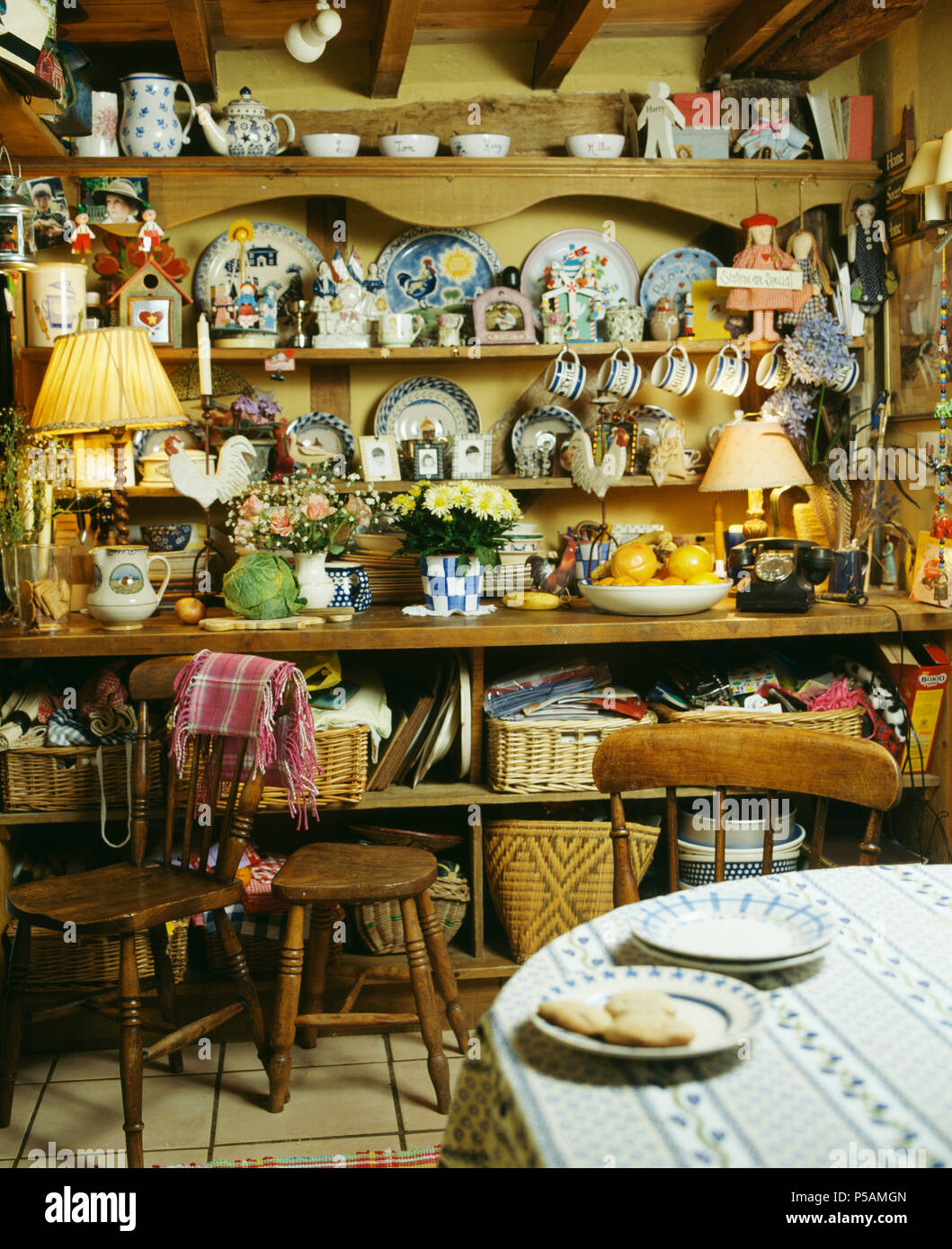 Sammlung von Keramik Tassen und Tellern auf antiken Kiefer Kommode im Cottage Küche Stockfoto