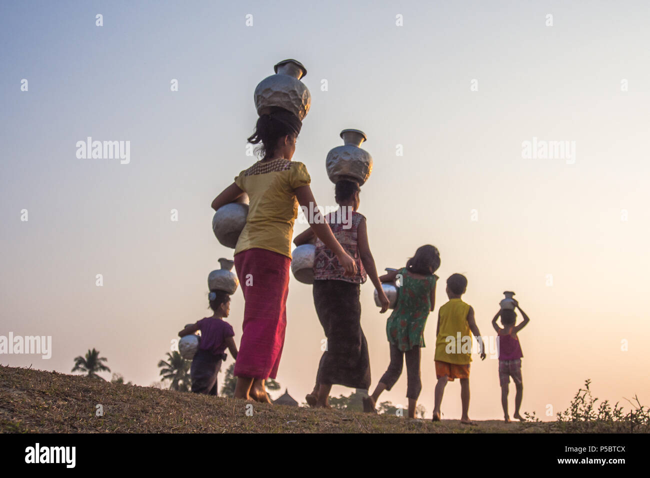 Frauen Gruppe zurück zu Home mit Wasser Topf, Mrauk u Myanmar Stockfoto