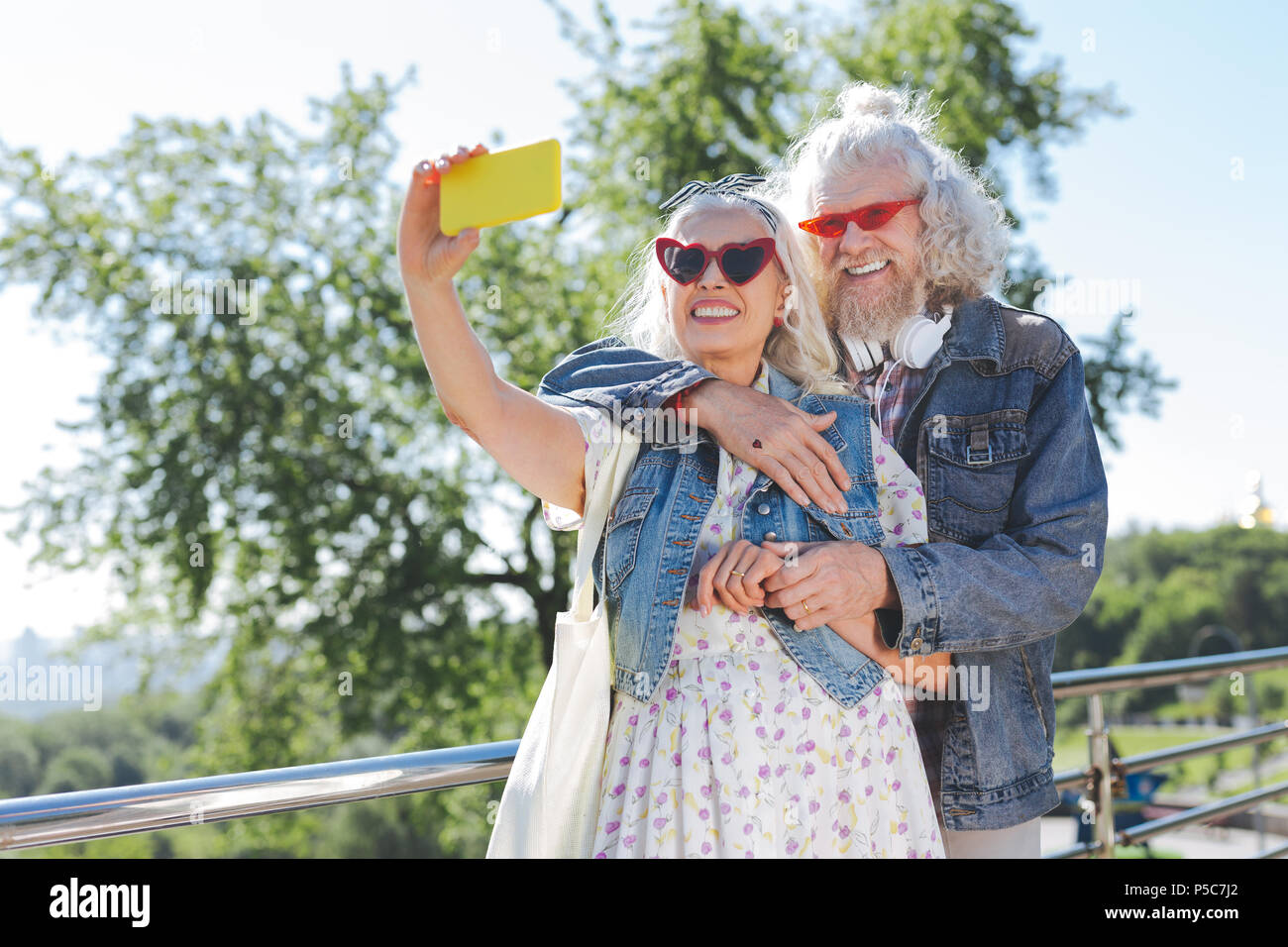 Freudige gealterte Frau selfies nehmen mit einem Smartphone Stockfoto