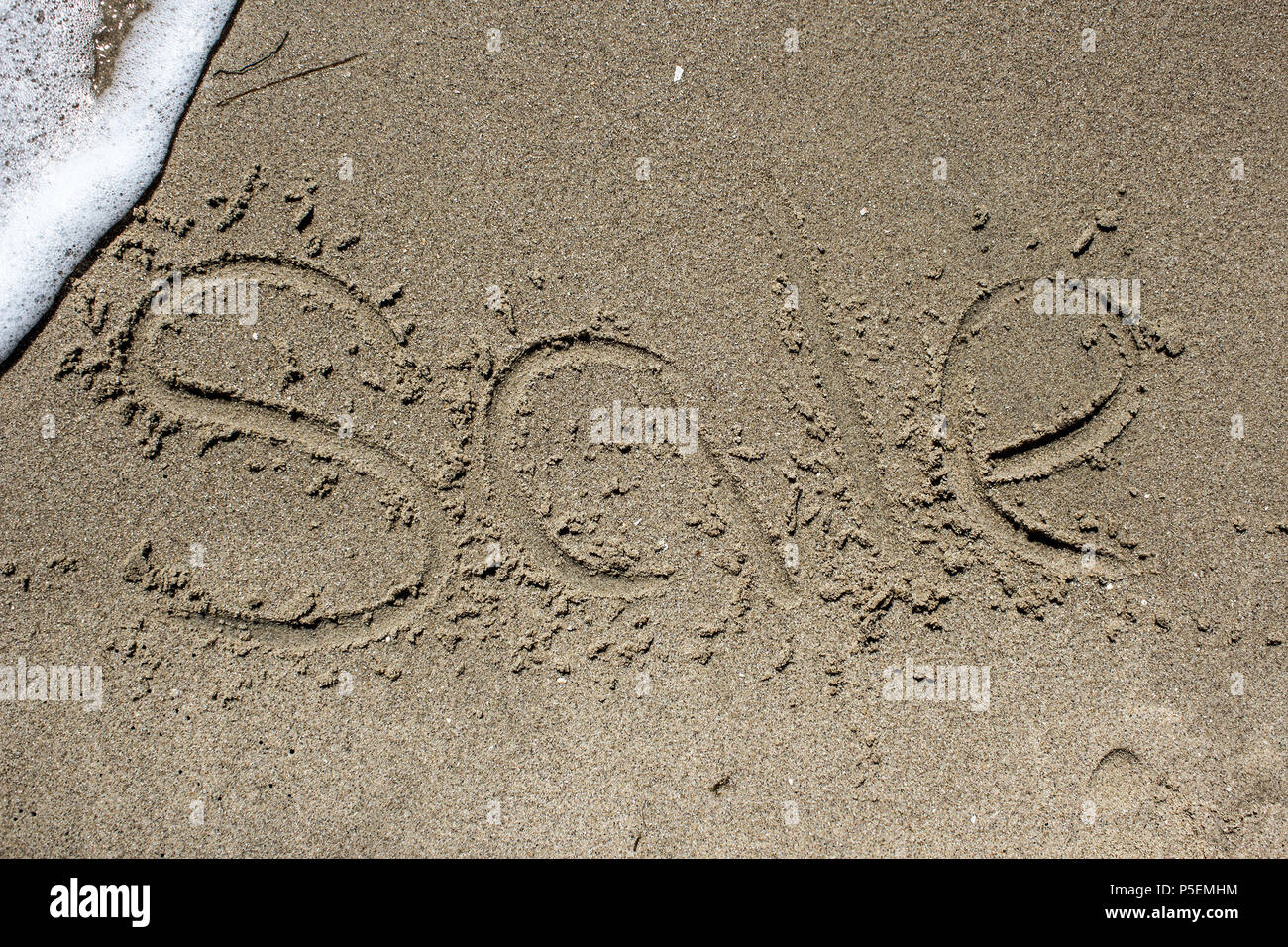 Verkauf. Wort auf den Sand Stockfoto