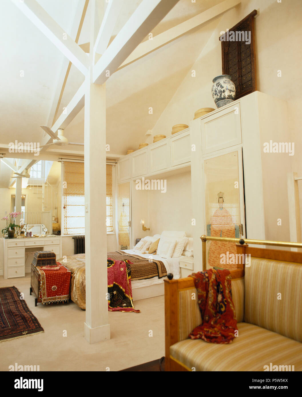 Gestreiften Sofa In Offenen Loft Conversion Schlafzimmer Mit Weiss Gestrichenen Unterstutzung Und Holzbalken An Der Decke Stockfotografie Alamy