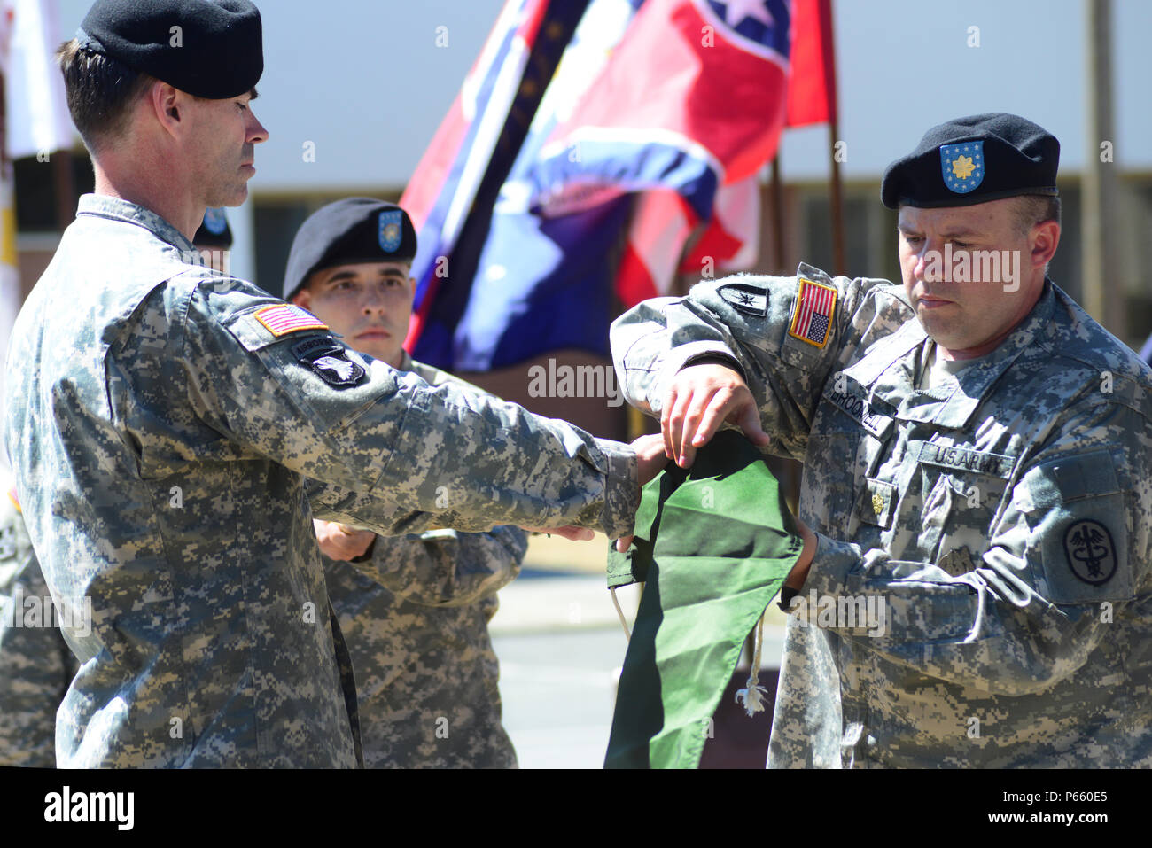 Von rechts, U.S. Army Maj Charles A. Broomell, ausgehende Loslösung OIC, U.S. Army Gesundheit Clinic-Livorno und US-Oberstleutnant Brian J. Bender Commander U.S. Army Gesundheit Clinic-Vicenza, sind, die die Flagge des US-Armee Gesundheit Klinik-Livorno während der Deaktivierung Zeremonie der US-Armee Gesundheit Clinic-Livorno im Camp Darby, Italien, 3. Mai 2016. (Foto von Elena Baladelli/freigegeben) Stockfoto