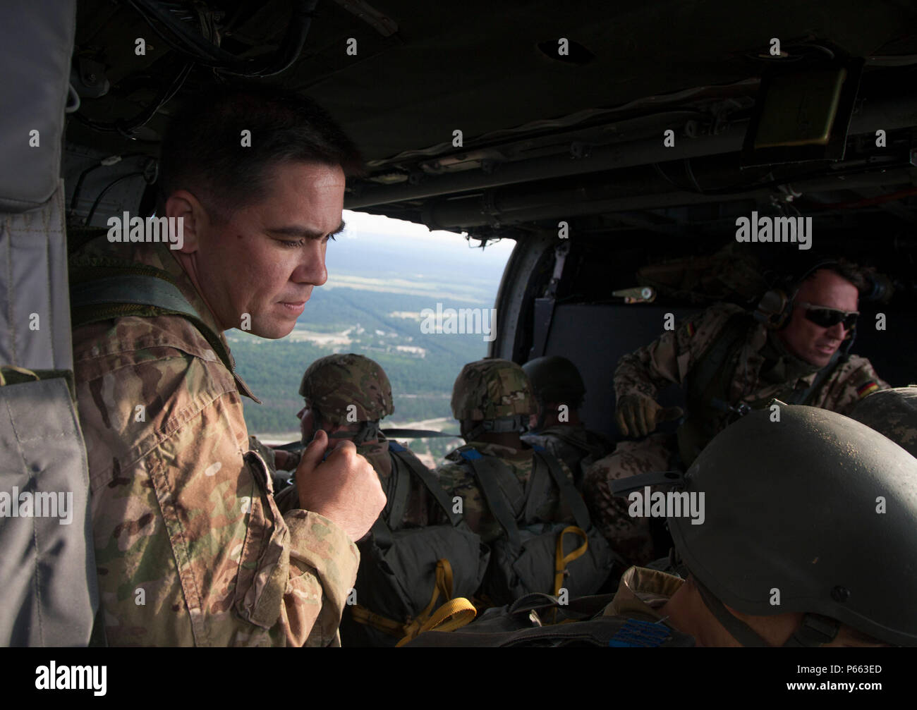 Us-Armee jumpmaster Sfc. Thomas Messer und Deutschen Airborne liaison Sgt. Maj. Hahnlein geben die 30 Sekunden Warnung an die Fallschirmjäger bei einem Betrieb in Fort Bragg, N.C., 5. Mai 2016. Die United States Army Special Operations Command (USASOC) und der Army Special Operations Aviation Befehl (ARSOAC) wurden Hosting ein Sprung von einem UH-60 Blackhawk zu gedenken Gesetz Tag und Währung in der kontingenz Missionen zu erhalten. (U.S. Armee Foto von SPC. Rachel Diehm/Freigegeben) Stockfoto