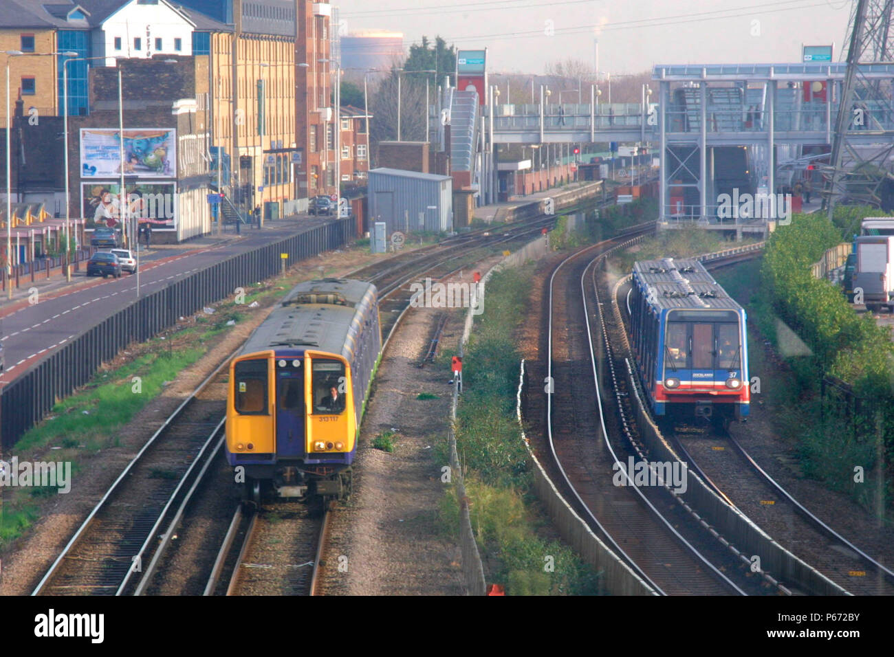 Ein Silverlink Metro Service übergibt einen Docklands Light Railway Einheit in der Nähe von Canary Wharf auf der North London Line. 2003. Stockfoto