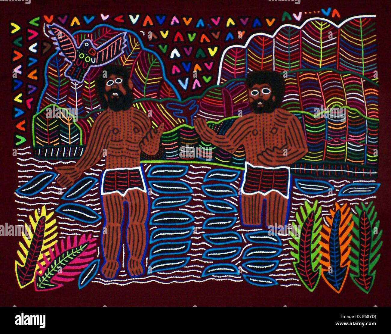 Mola textile von Kuna indische Künstler, die eine biblische Szene. Von den San Blas Archipel, Panama. Reverse applique Design auf weibliche Bluse getragen. Johannes tauft Jesus im Jordan. Stockfoto