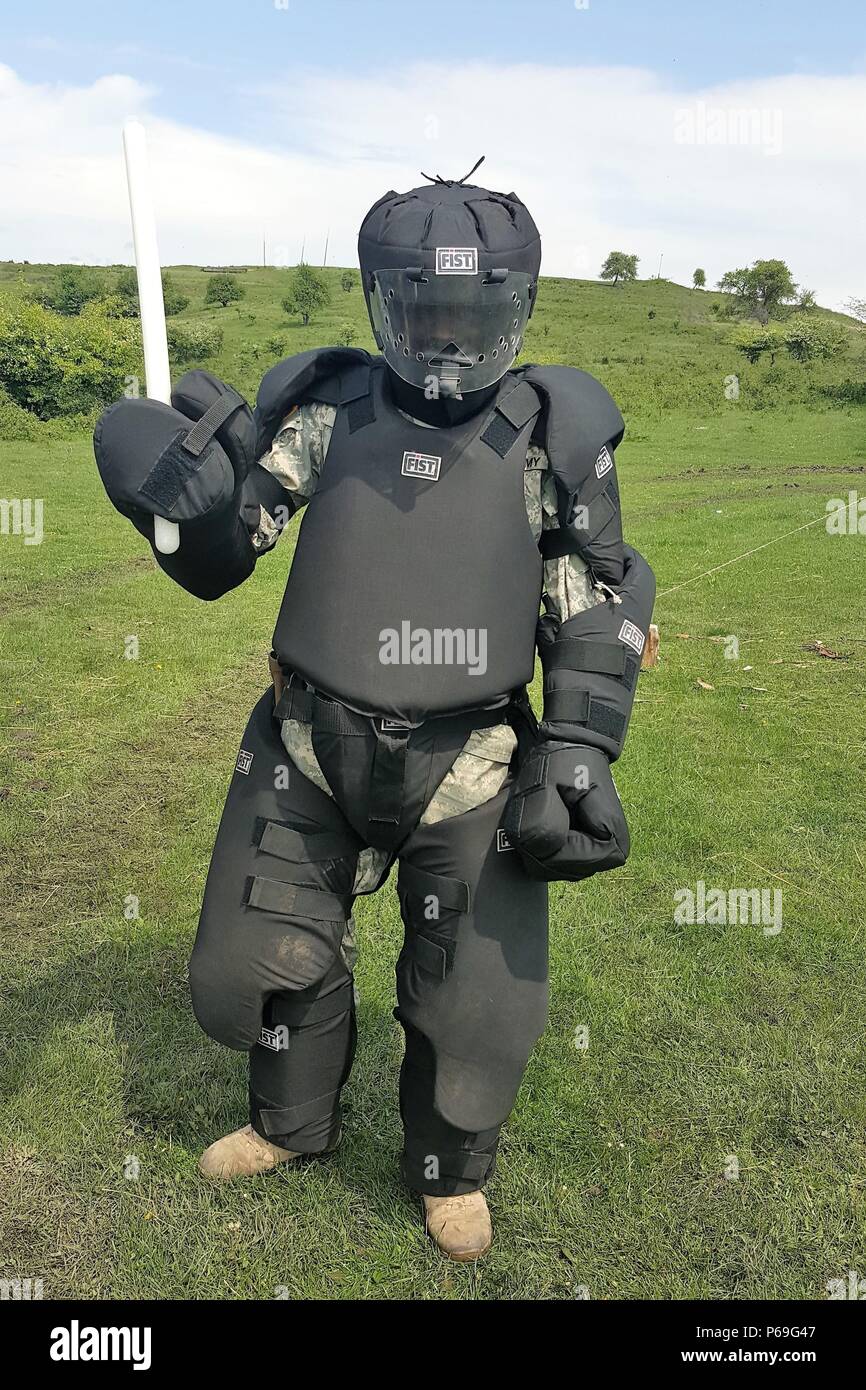 In der "Roten Mann Anzug" ist Spc. Landon Glover, der Militärpolizei der 1165Th Military Police Company, Alabama National Guard zugewiesen wird, wie die bedrohliche Ziel für Baton einzelnen Streiks und Aufständen Training am 10. Mai 2016 in Cincu Training Strecke, Rumänien handeln. Die taktische Baton ist einer von mehreren nicht-tödliche Waffen, die von den militärischen Polizisten für den Schutz gegen unmittelbare Bedrohungen verwenden. MPs wird beigebracht, wie und wann Sie taktvoll und effektiv durchführen und den Staffelstab verwenden, während selbstbewusst die Kontrolle über ihre Gegner. (U.S. Armee Foto vom Kapitän Ryan E. Schwarz, 877Th Engineer Battalio Stockfoto