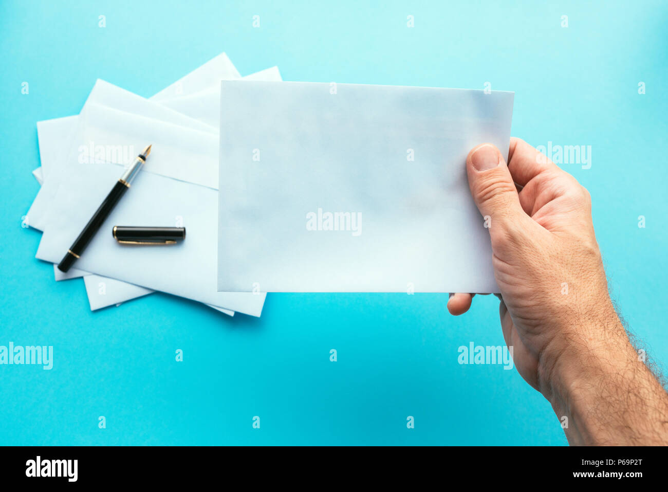 Hand mit leeren weißen Umschlag, Mock-up-Bild für Kommunikation und Korrespondenz Themen Stockfoto