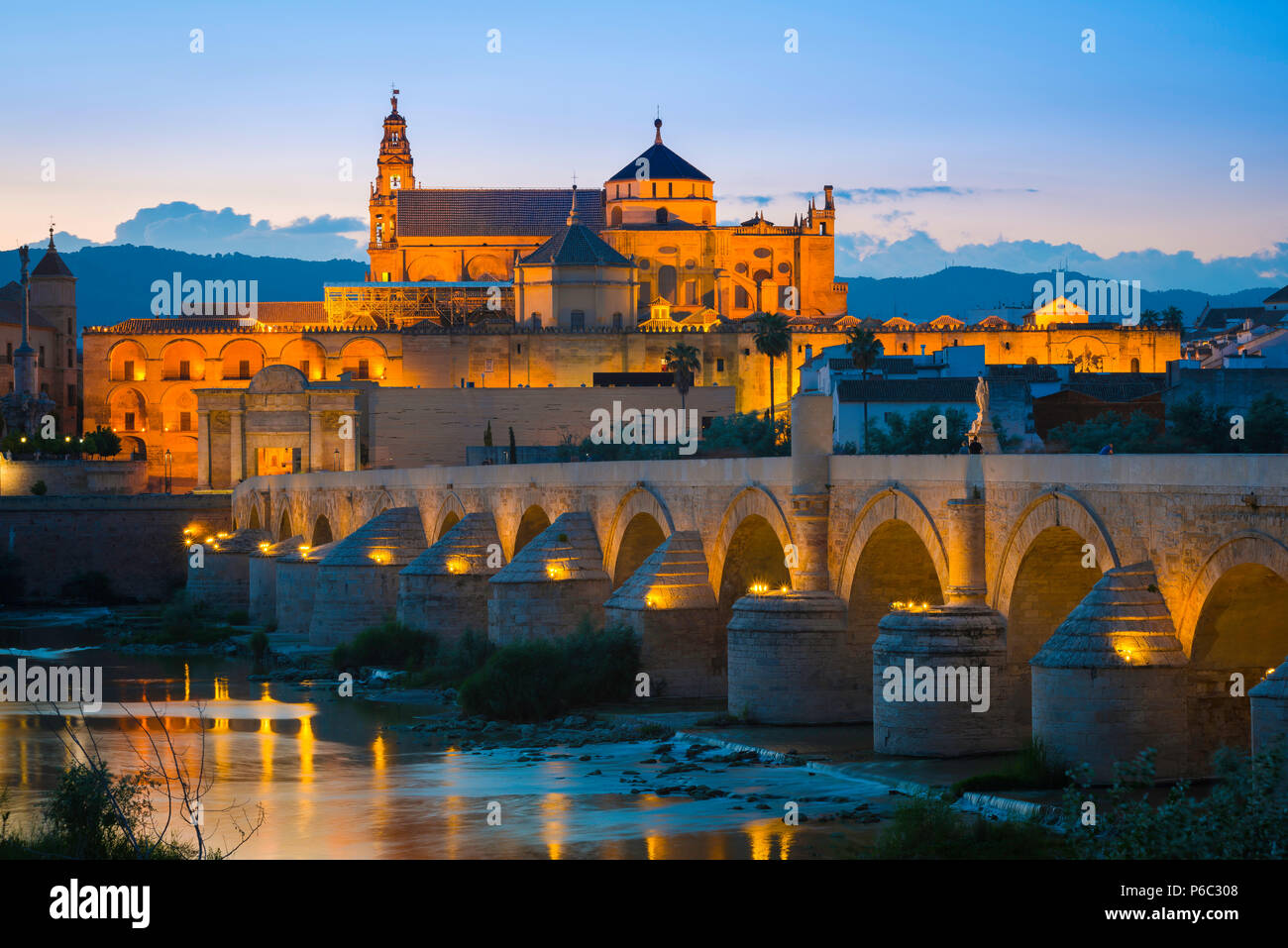 Spanien Reise Andalusien, Blick bei Nacht über die römische Brücke auf dem Rio Guadalquivir in Richtung der Moschee Kathedrale von La Mezquita in Cordoba, Spanien. Stockfoto
