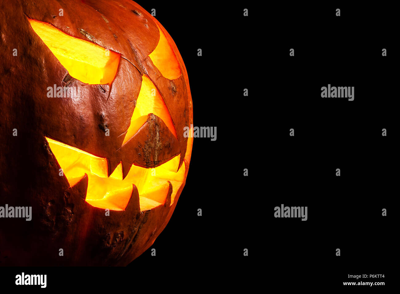 Drei Viertel ansehen Spooky Halloween Kürbis Jack O Lantern glänzend innerhalb von isolierten Stockfoto