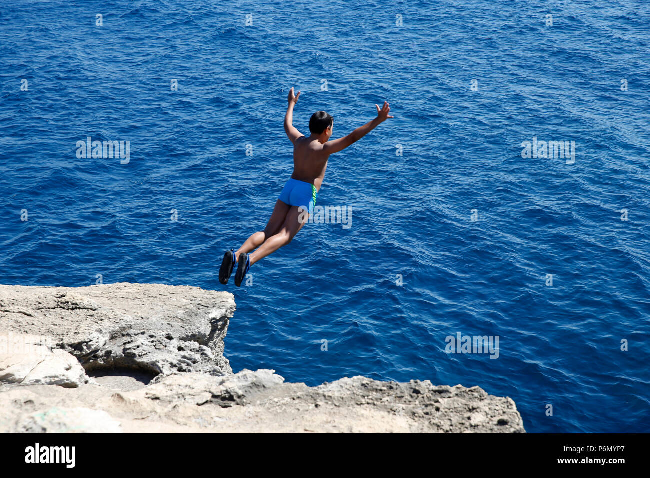 11-jähriger Junge von einem Felsen ins Meer im Salento, Italien springen. Stockfoto 11-jähriger Junge von einem Felsen ins Meer im Salento, Italien springen. Stockfoto