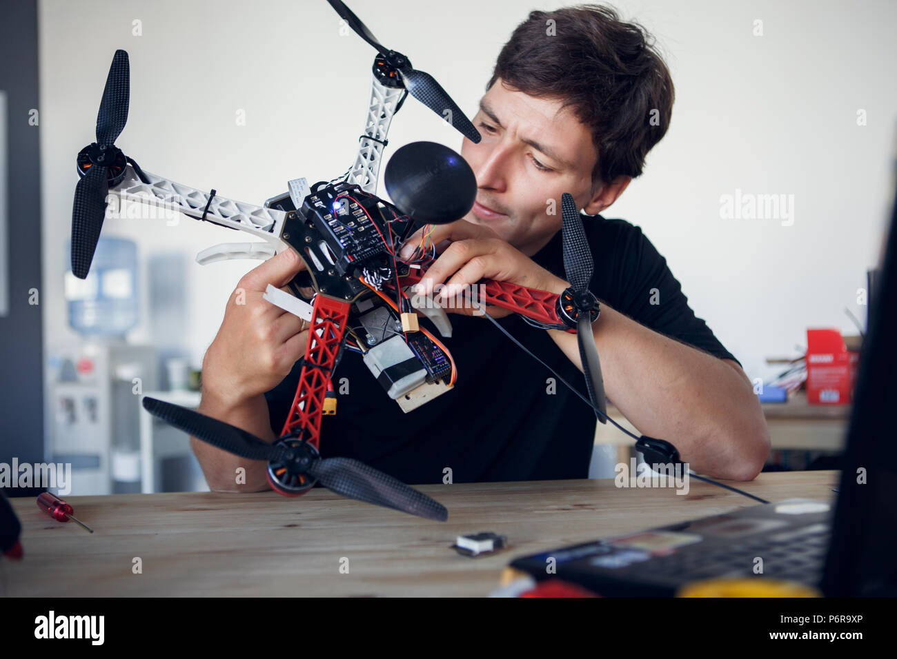 Bild der junge Ingenieur zur Festsetzung square Copter am Tisch Stockfoto