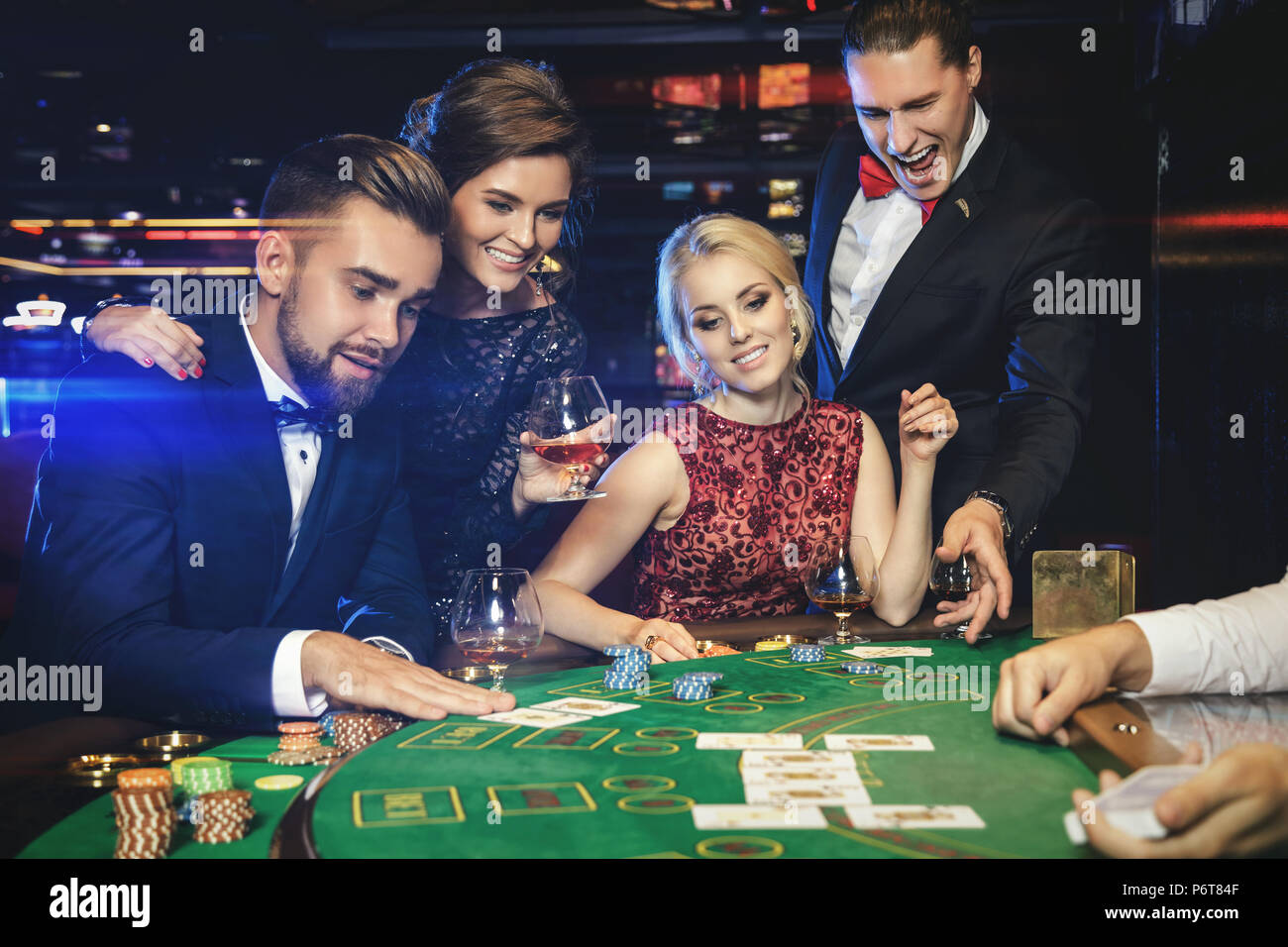 Glücklich und reiche Leute ihre Freunde gewinnen Feiern nach dem erfolgreichen Spiel im Casino. Konzepte von Luxus leben, Reichtum und spielende Industrie Stockfoto
