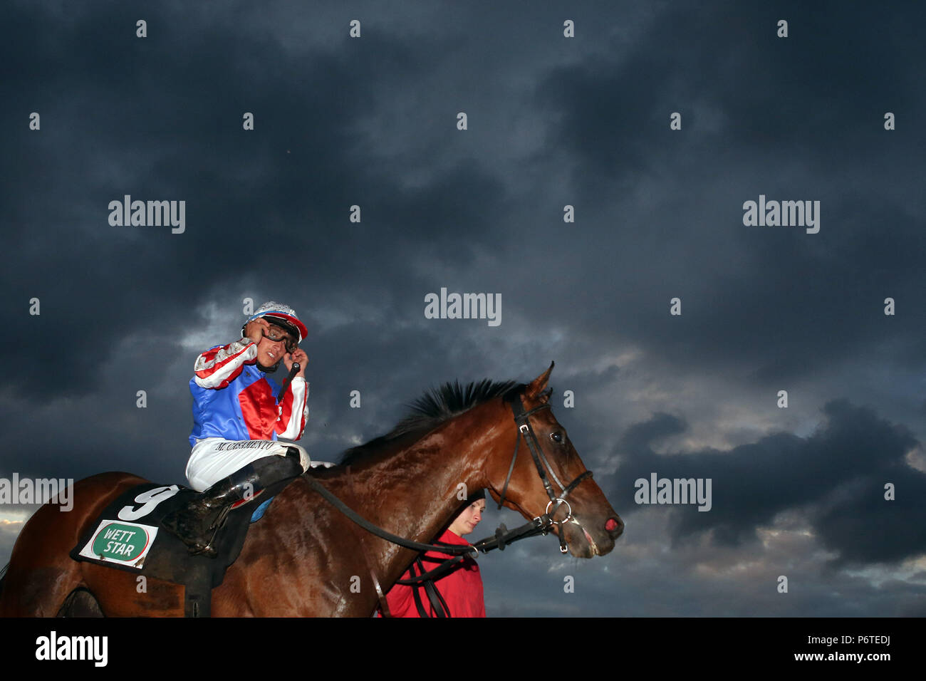 Hamburg, Pferd und Jockey vor dunklen Gewitterwolken Stockfoto