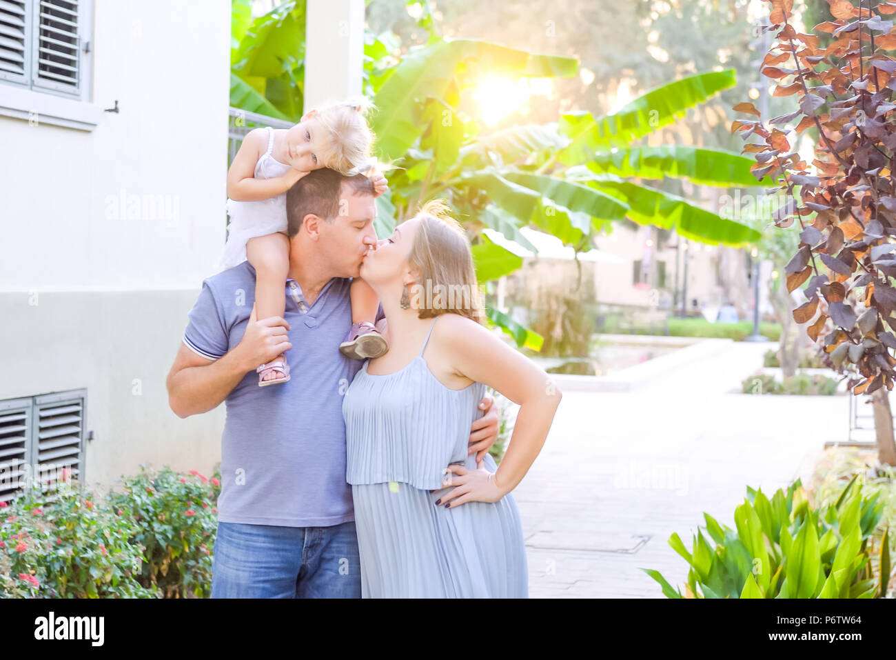 Glückliche Familie von drei - schwangere Mutter, Vater und Tochter umarmen, Lachen, Spaß in der Sunset Park. Familie Erholung, Zeit bereitgestellt Stockfoto
