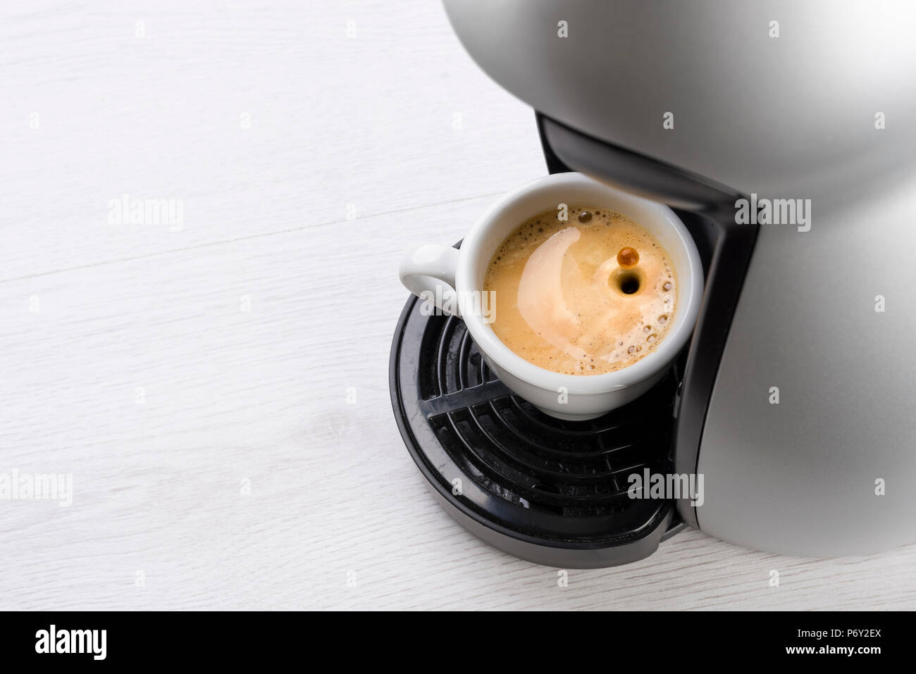 Tasse Kaffee nur gefüllt auf der Maschine mit Drop springen Stockfoto
