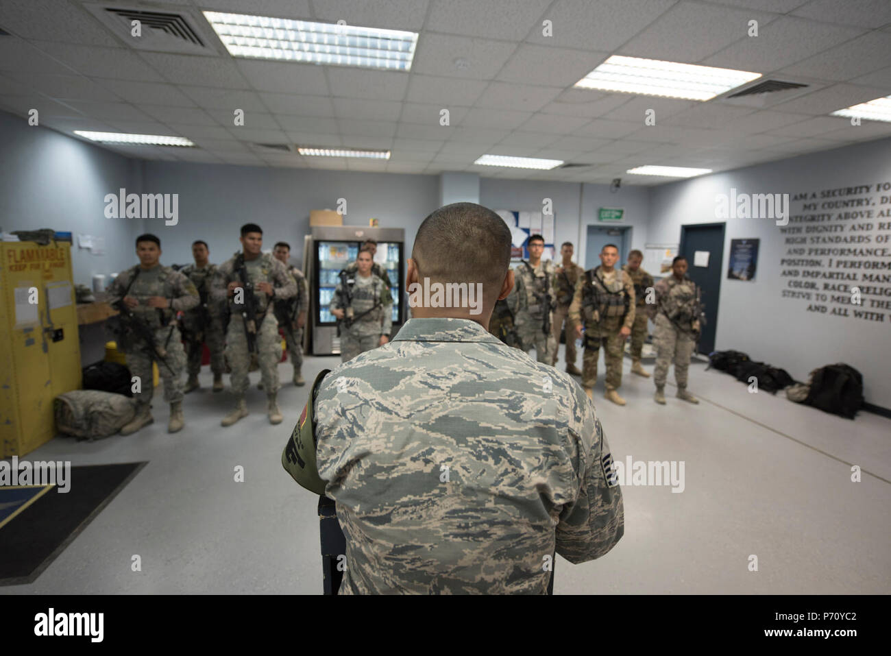 Us Air National Guard Master Sgt. Oscar Espinosa, 407 Expeditionary Sicherheitskräfte Flug Chief, gibt Anweisungen zum Flieger und US-Marines während einer Wache briefing Mai 10, 2017 Berg, im Südwesten Asien. Espinosa, Scots Guards mit der 254Th Security Forces Squadron von Andersen Air Force Base, eingesetzt zur Unterstützung der Operation inhärenten Lösen. Als Flug Chief, Espinosa Koordinaten Gate Guard und Patrol Teams aus beiden Dienstleistungen und internationale Koalition Mitglieder. Stockfoto