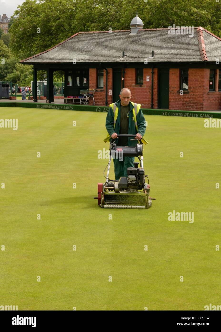 Ein Stadtrat Glasgow Arbeiter Mähen Das bowling green Rasen an Kelvingrove, Glasgow, Schottland, Großbritannien Stockfoto