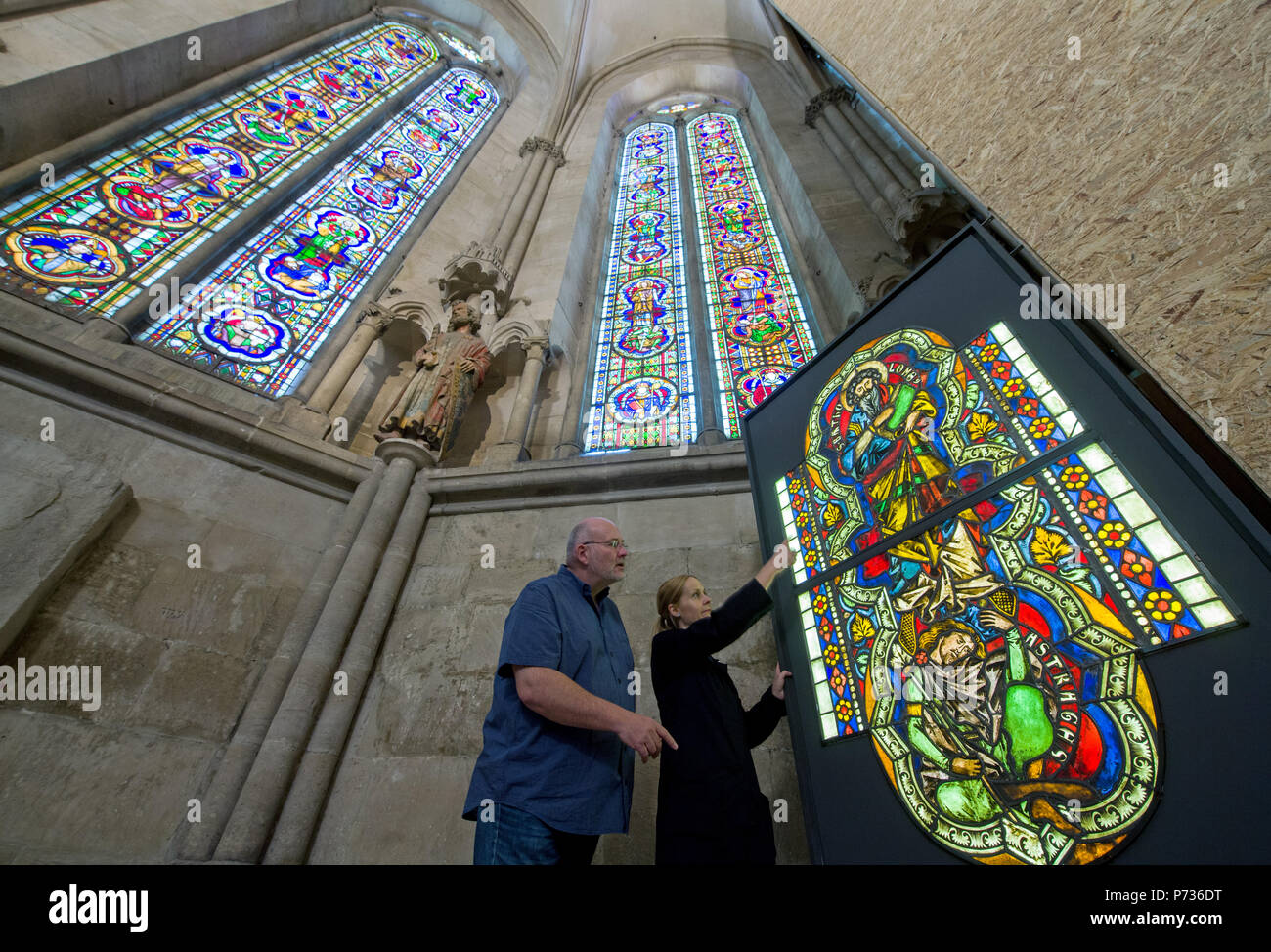 28.06.2018, Sachsen-Anhalt, Naumburg: Ivo Rauch, Project Manager, und Sarah Jarron, Direktor der gläsernen Restaurierungswerkstatt, untersuchen Sie eine konservierte Glasscheibe im Westen Chor der Naumburger Dom mit der Darstellung des Apostels Bartholomaus (oben) und seine Widersacher Astyages. Die Fenster gehören zu den wertvollen Bestand aus Glas der Naumburg West Chor aus dem späten 13. Jahrhundert. Seit Dezember, die herrlichen Fenster der Westen Chor haben durch ein Team von Experten restauriert und pravently gesichert. Es wird erwartet, dass das erste Fenster fertig wird und am Anfang von Octob installiert werden. Stockfoto