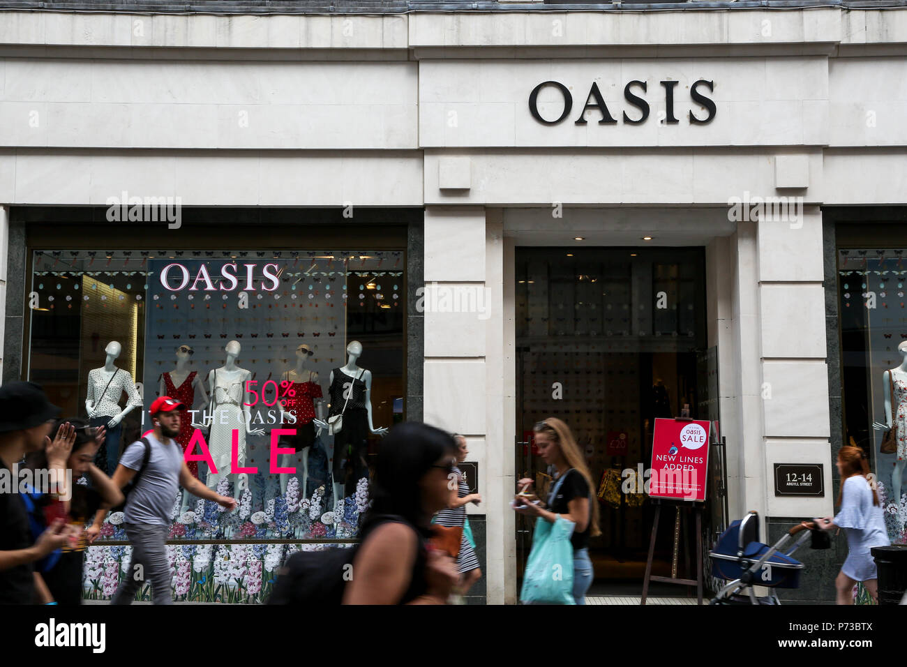 Die Oxford Street London. UK vom 4. Juli 2018 - Sommer in Oase Store auf der Oxford Street. Käufer vorbei an den Summer Sale Fenster angezeigt, in den Geschäften in der Oxford Street im Londoner West End. Credit: Dinendra Haria/Alamy leben Nachrichten Stockfoto