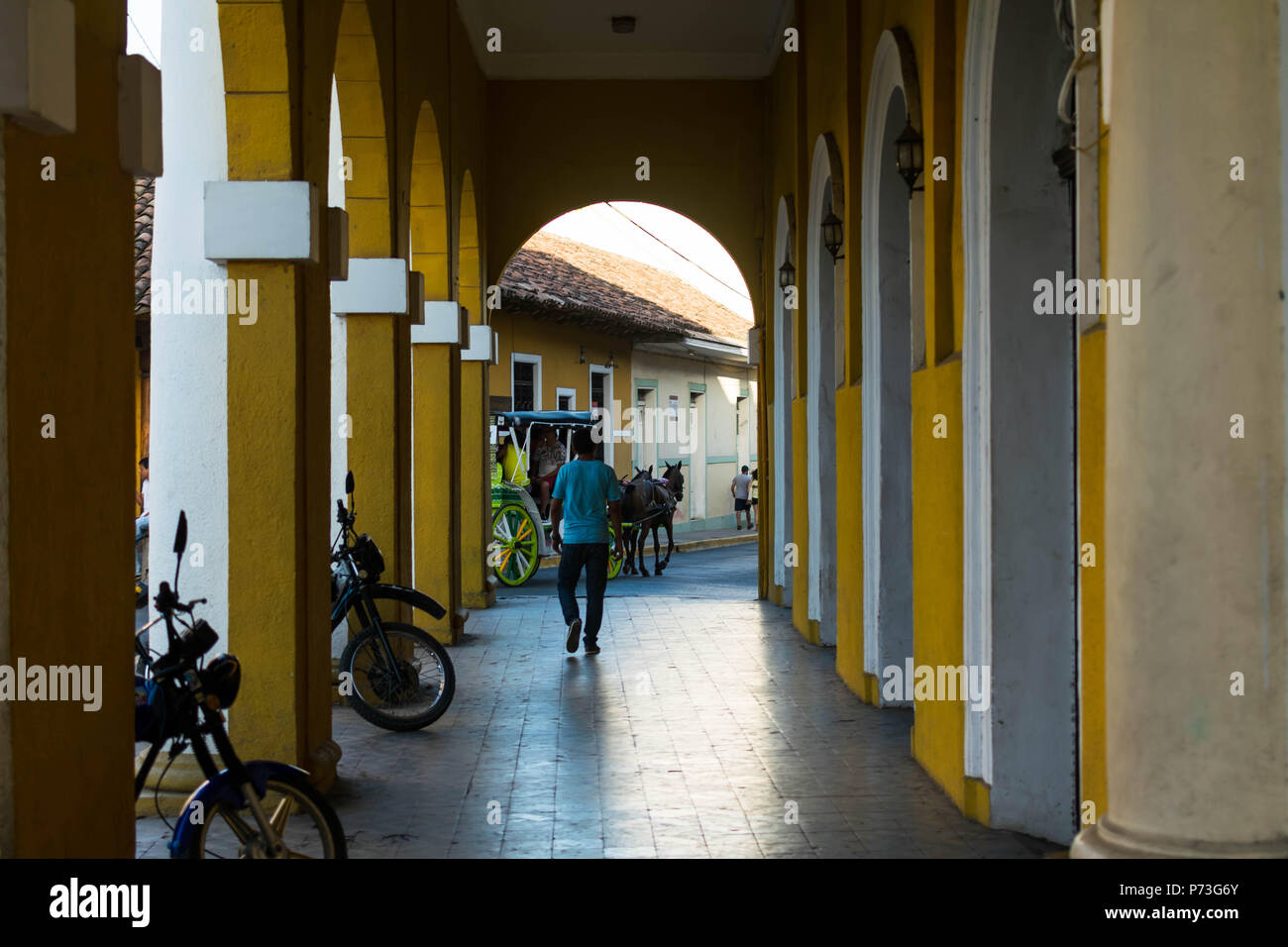 Granada, Nicaragua. Februar 7, 2018. Eine Person, die unter den Arkaden des Gebäudes in der Nähe der Kathedrale von Granada Stockfoto