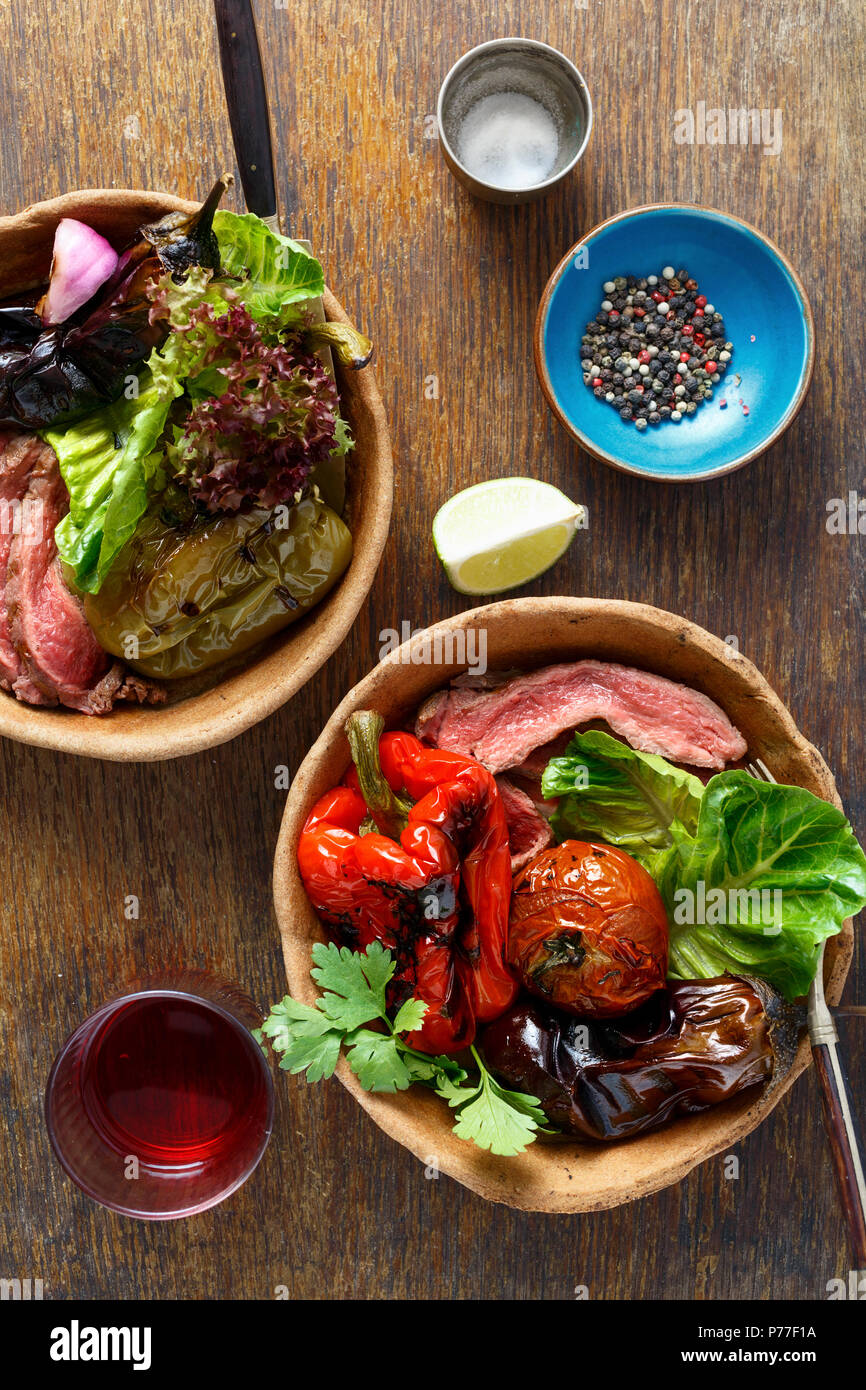 Ansicht von oben gegrillte Steaks und gegrilltem Gemüse serviert mit Brot Platte auf hölzernen Tisch Stockfoto