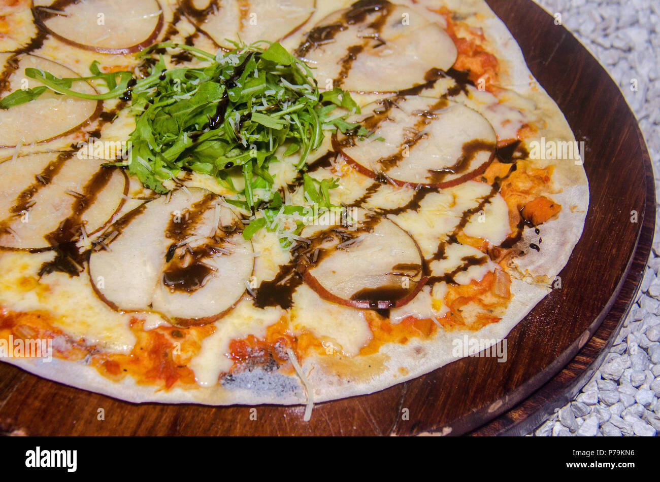 Handwerkliche Pizza auf eine Holzplatte Stockfoto