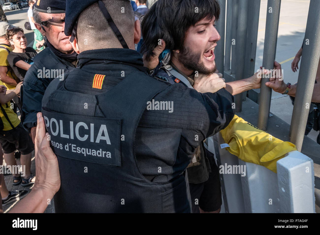 Eine Demonstrantin iseen gegen die Bars von der Polizei geschoben werden. Die Mobilisierung der Bevölkerung gegen die öffentliche Auktion einen Satz von Eigenschaften entsprechenden Vererbungen zu erbengemeinschaften hat es geschafft, den Start der Auktion für 10:00 Uhr Trotz der starken Widerstand der Bevölkerung, die auktionatoren und Käufer zugreifen, haben die Site wurde mit Hilfe der katalanischen Polizei Mossos d'Esquadra zu verzögern. Den ganzen Morgen haben kleine Auseinandersetzungen zwischen Aktivistinnen und Polizei. Stockfoto