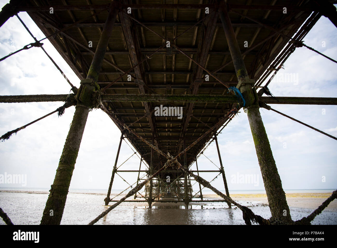 Worthing Pier Rahmen bei Ebbe an einem Sommertag Schuß von direkt unter. Stockfoto
