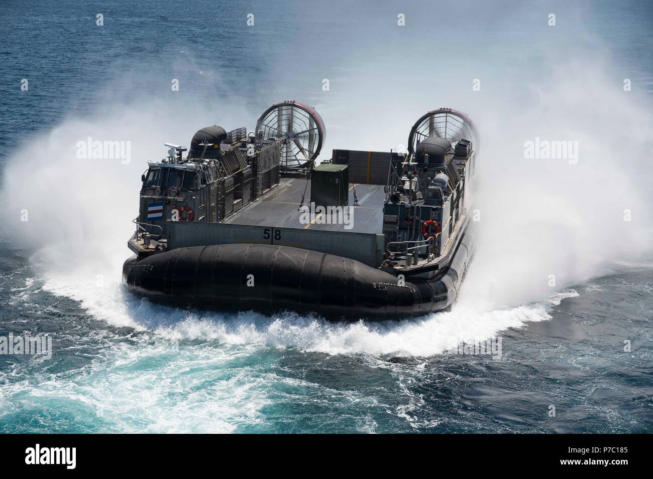 180703-N-XK 809-121 PAZIFISCHEN OZEAN (3. Juli 2018) Landing Craft air cushion (LCAC) 58, zugeordnet zu den Angriff Craft Unit (ACU) 5, Ansätze der gut Deck des Amphibious Assault ship USS BONHOMME RICHARD (LHD6). Bonhomme Richard ist derzeit in den USA 3 Flotte Bereich der Operationen. (U.S. Marine Foto von Mass Communication Specialist 3. Klasse William Sykes) Stockfoto