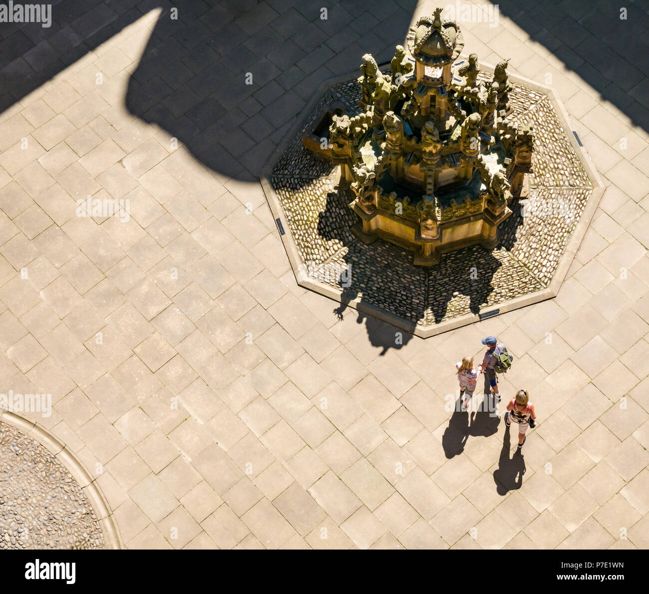 Auf einen zentralen Innenhof mit verzierten Stein Brunnen mit Schatten der Menschen im Sommer Sonnenschein, Linlithgow Palace, West Lothian, Schottland, Großbritannien Stockfoto