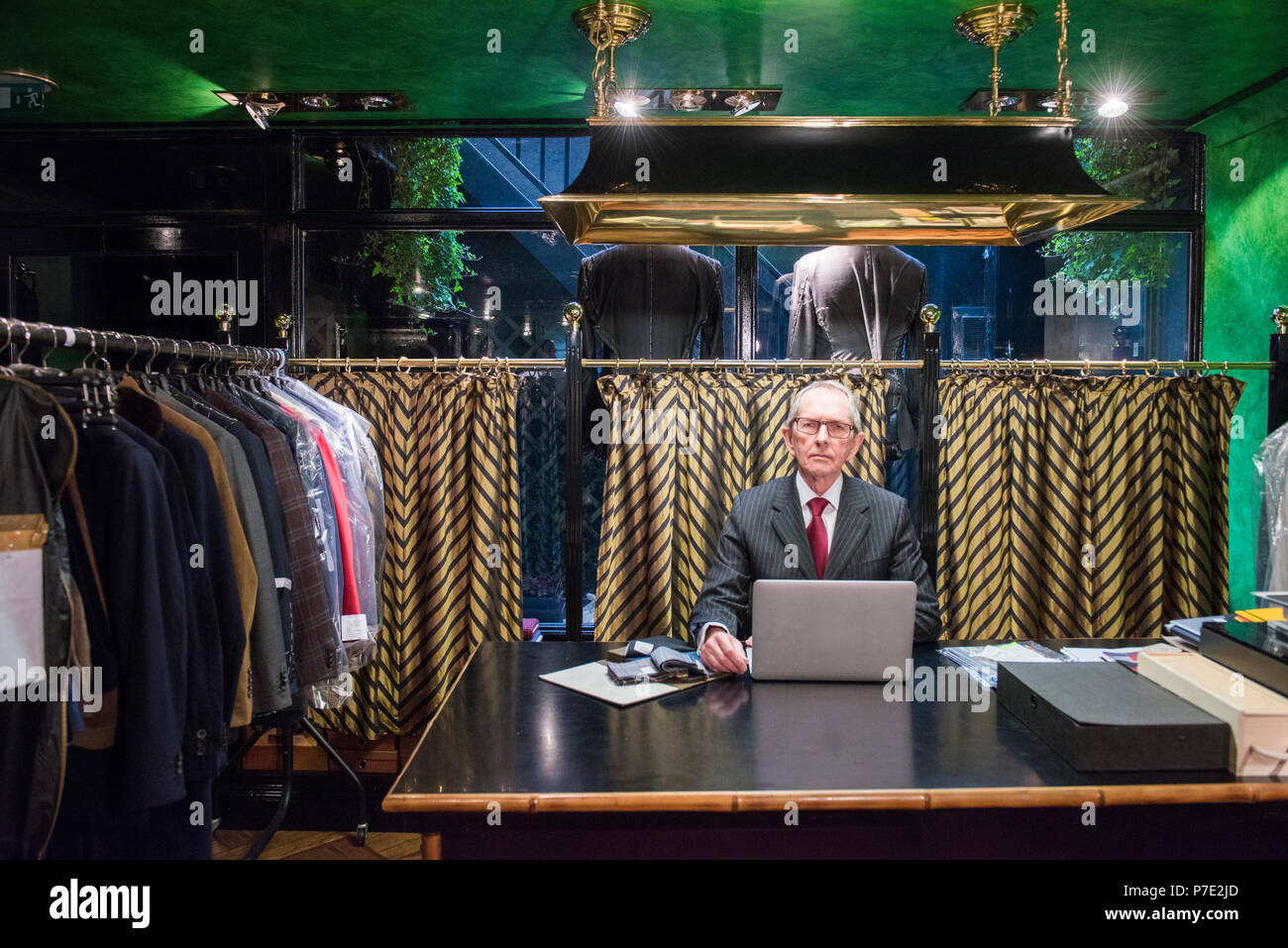 Senior Schneider am Schreibtisch mit Laptop in der traditionellen Schneider, Porträt Stockfoto