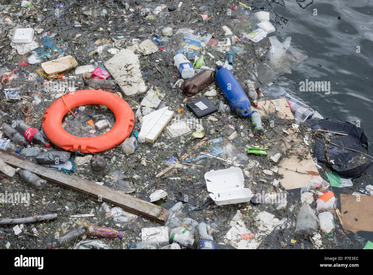 Kunststoff Flaschen und Müll und Rettungsring floating in Großbritannien. Stockfoto