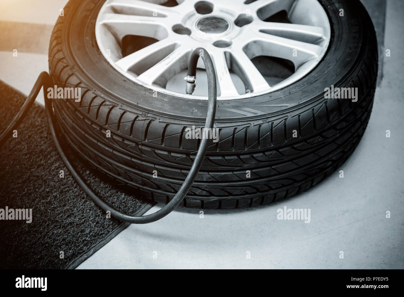 Füllen die Luft in einem Auto Reifen - Schwarz und Weiß und Sonnenlicht  filter Effekt. Sie können schnell und einfach befüllen Sie die Reifen Ihres  Autos mit einem Haus oder Gas stat