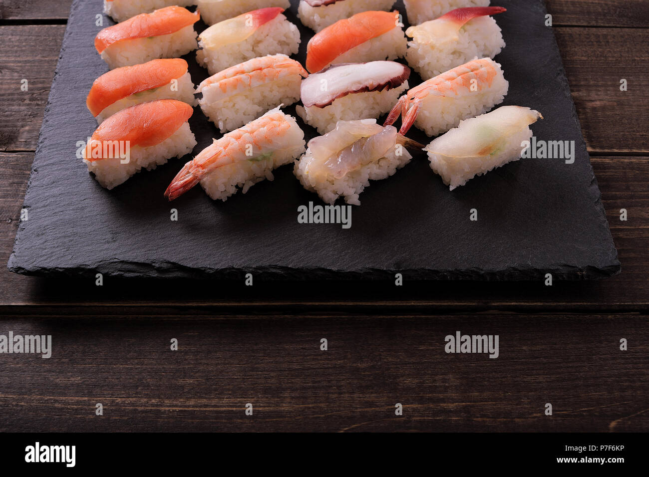 Sushi japanische Küche schwarzer Schiefer Servierplatte Holz Tisch Stockfoto