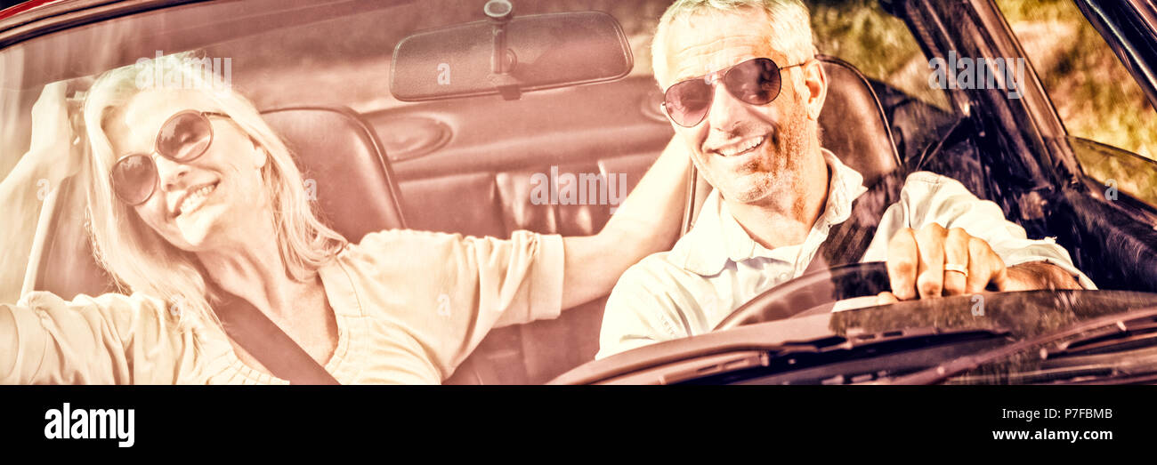 Gerne älteres Paar im roten Cabrio Stockfoto