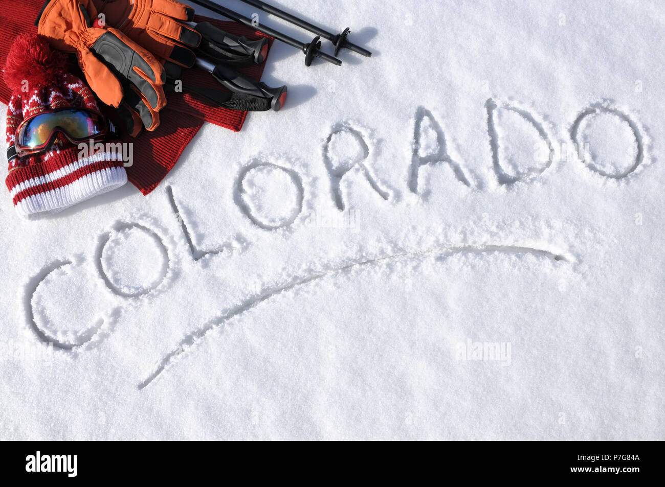 Das Wort Colorado im Schnee mit Ski Stöcke, Schutzbrille und Hüte geschrieben. Stockfoto