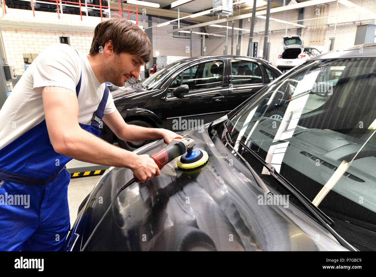 Mann in einem Workshop Reinigung ein Auto - Service für den Kunden Stockfoto