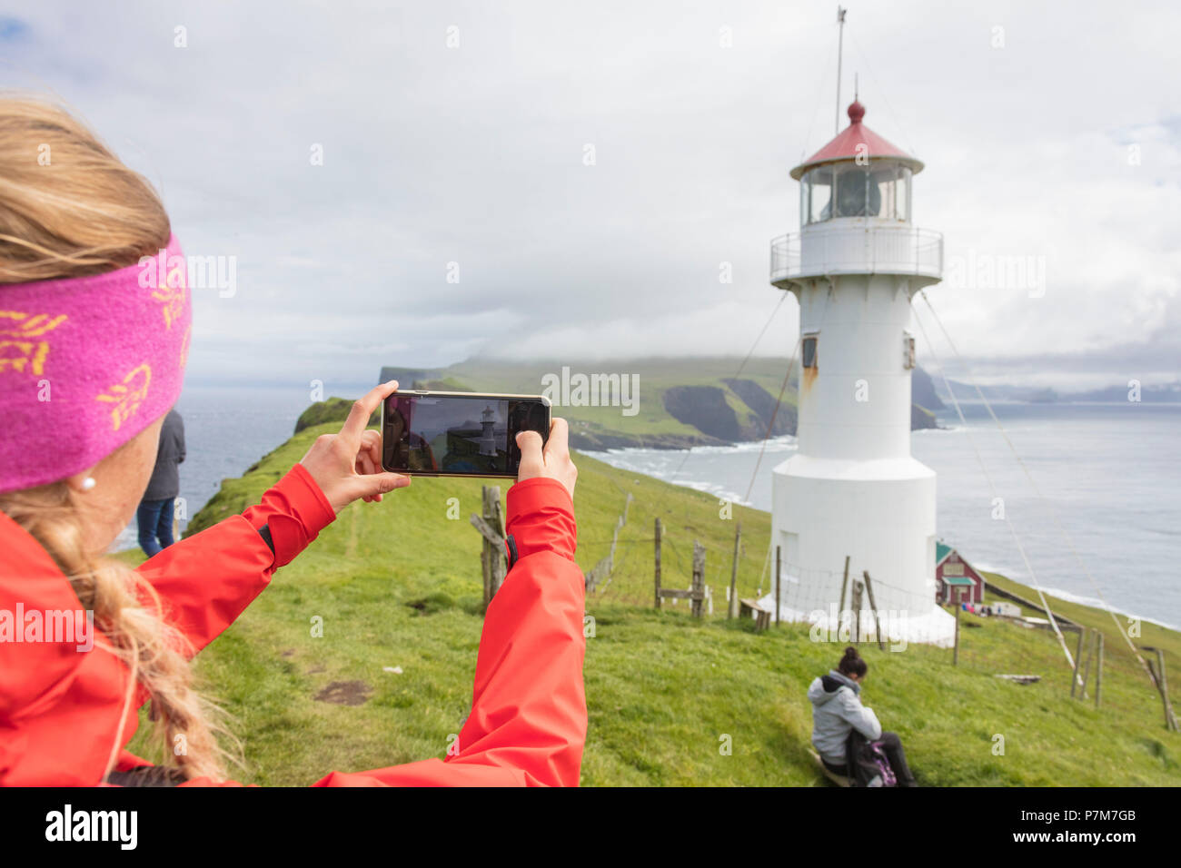 Touristische nimmt Bilder der Leuchtturm auf der Insel wie Mykines Holm, Mykines Island, Färöer, Dänemark bekannt Stockfoto