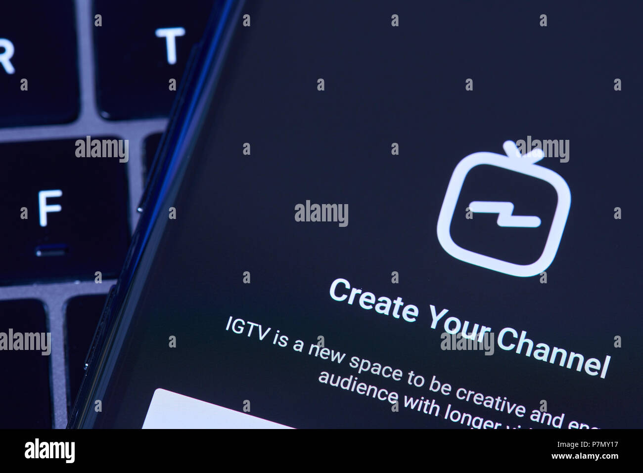 New York, USA - Juli 6, 2018: Erstellen von IGTV Kanal in Instagram mit Bildschirm des Smartphones lag auf Laptop Tastatur Stockfoto