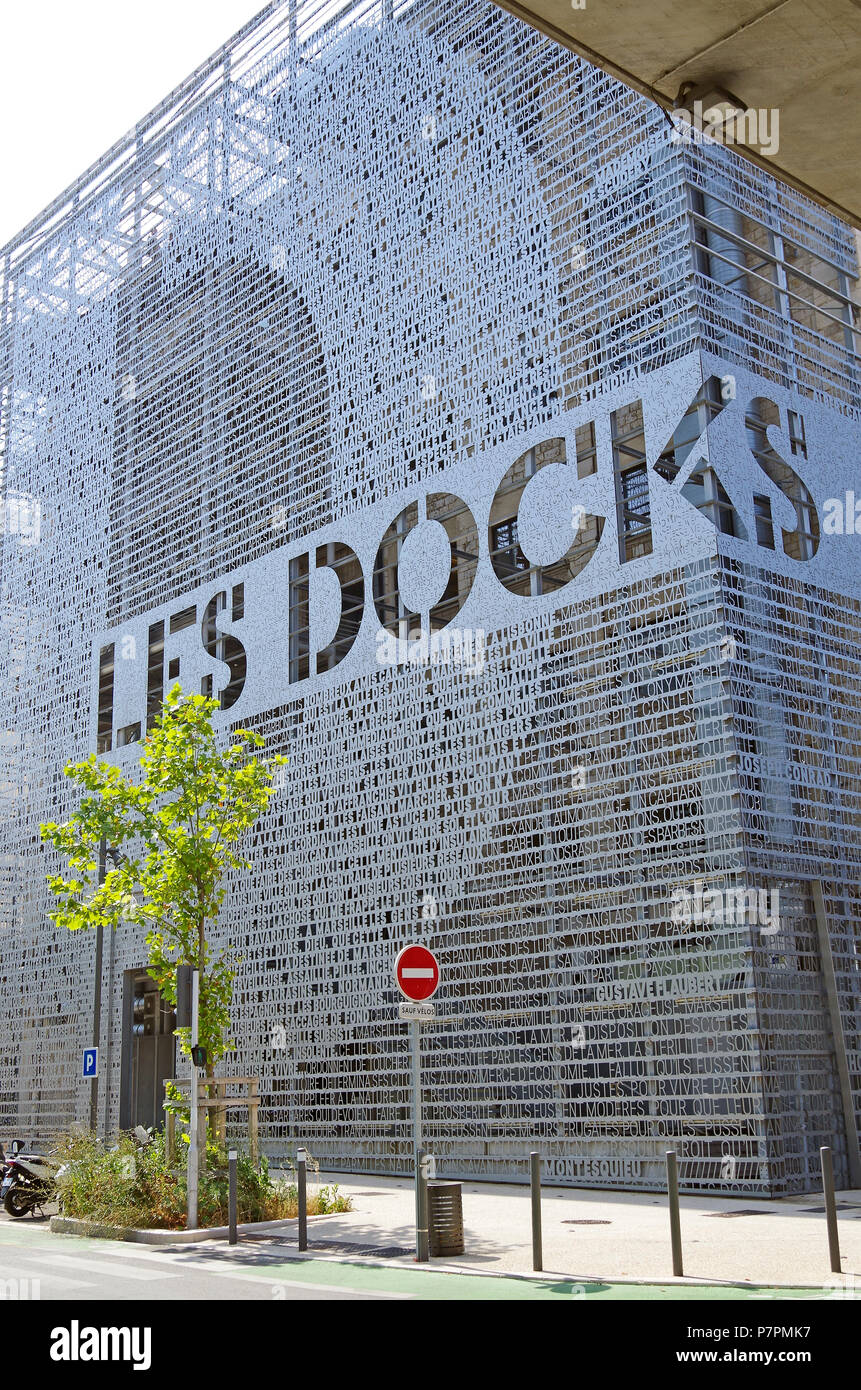 Fabelhafte Metallsieb mit ausgeschnittenen Buchstaben auf einem Ende der ehemaligen Lagerhalle, die jetzt Les Docks Dorf, eine Marseille Shopping und Office Center Stockfoto