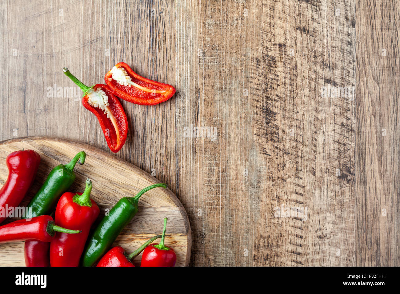 Rote und grüne Chili Pfeffer in einer Schüssel auf hölzernen Tisch mit Platz kopieren Stockfoto