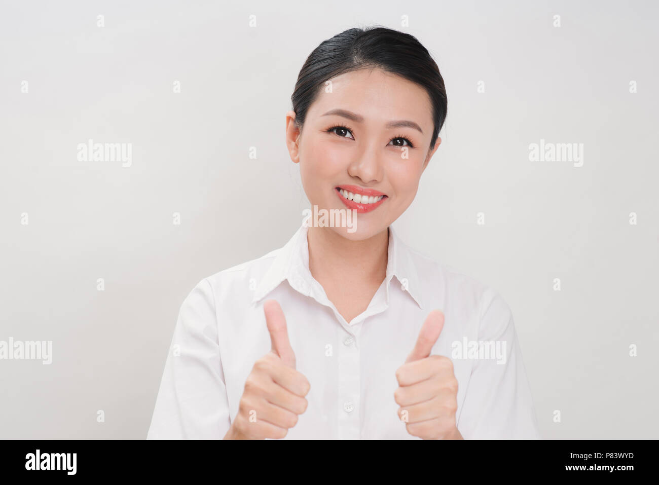 Asian Business Frauen lächeln und Thump up Hand Zeichen für gerne auf weißem Hintergrund Stockfoto