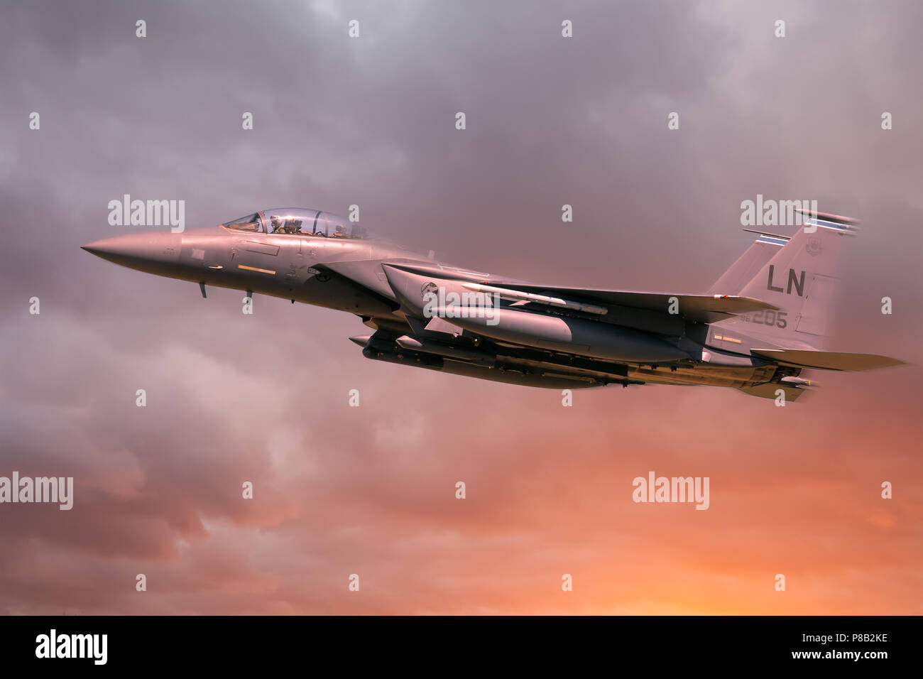 RAF Lakenheath, Suffolk, England, 21. Juni 2018. United States Air Force F-15 Eagle im Flug mit orange Sonne und Wolken Stockfoto