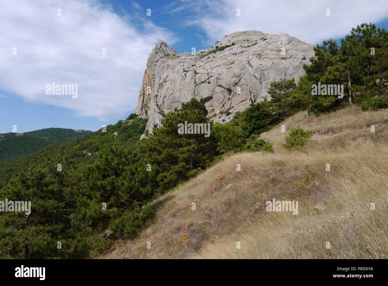 Eine Klippe auf einem grünen Hang stützte, die von der Spitze mit einem Gewölbe des Himmels. Für ihr Design Stockfoto