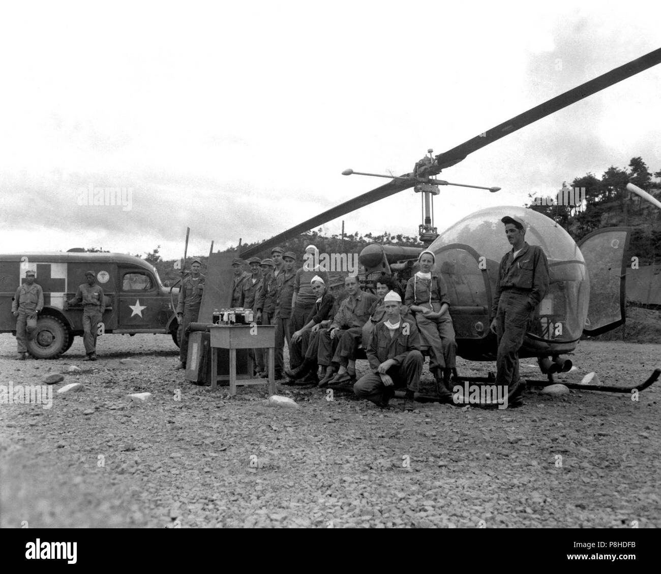 8225Th MASH Personal mit H-13 Helo in Korea 1951. Personal und Ausrüstung, die benötigt wird, um den Menschen das Leben zu retten sind an HQs Der 8225Th Mobile Army Surgical Hospital, Korea montiert. Oktober 14, 1951. Cpl. Charles Abrahamson. (Armee) Stockfoto