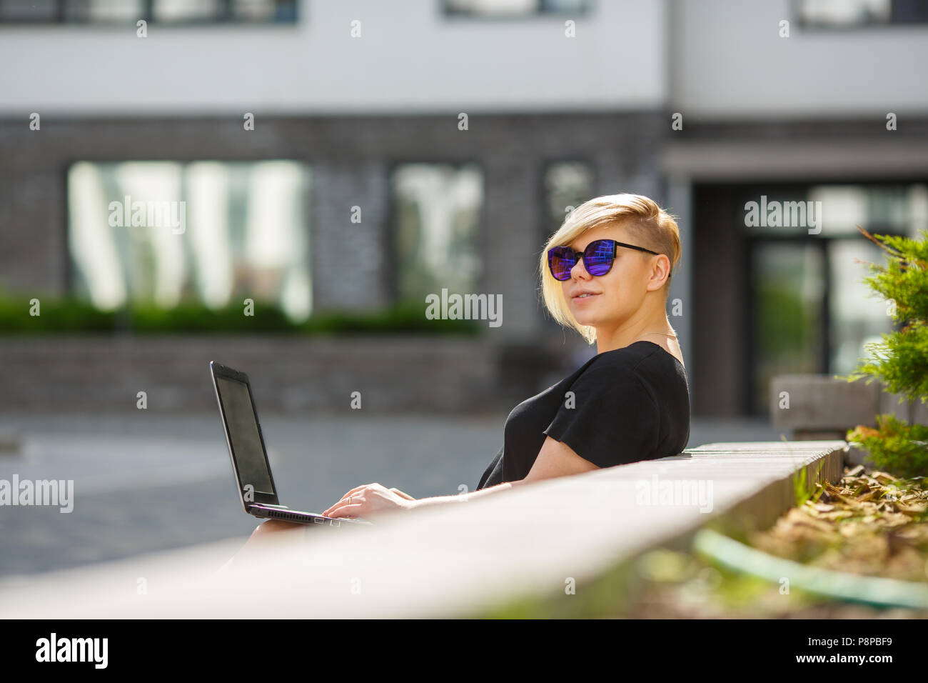 Mädchen in der Sonne Brille plus Größe ist auf hellen, sonnigen Tag fröhlich auf der Straße, Haarschnitt kreativ. Student bestandenen Prüfungen, Vorbereitung, Eingabe der Universität Stockfoto